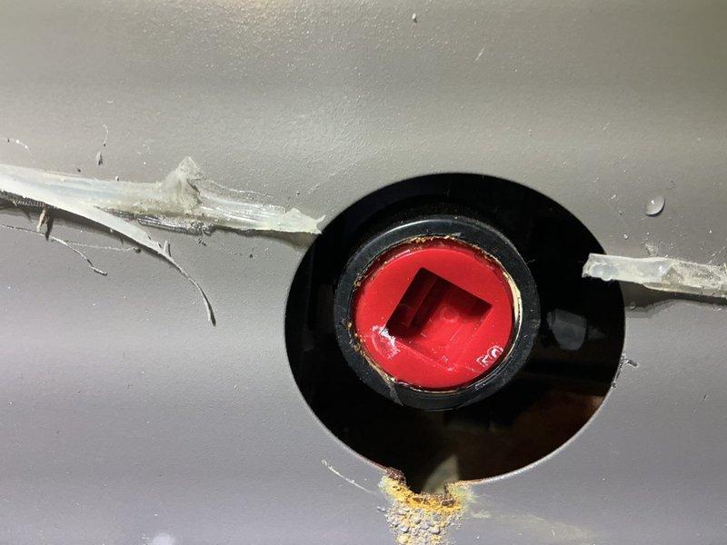 Responded to service call for 20-year-old furnace with reported water leak causing internal rust formation. Upon inspection, identified deteriorated condensate drain components with failing sealant around drain fitting and significant corrosion on metal piping. Documented conditions showing compromised drain assembly with visible rust accumulation on metal components and degraded sealing materials allowing moisture intrusion. Furnace remained operational at time of inspection, with leak source traced to condensate drainage system requiring attention to prevent further water damage and corrosion to unit.