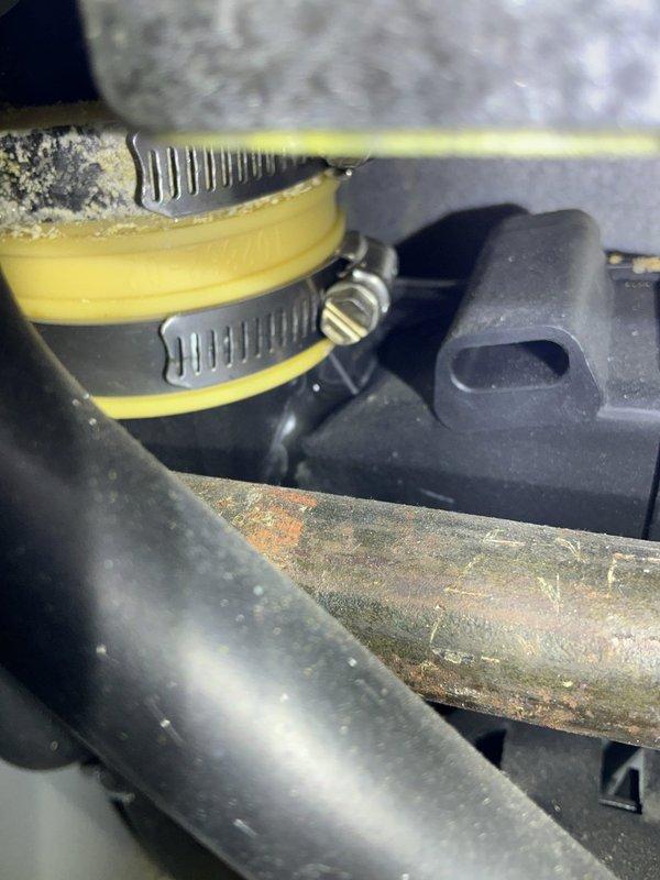 Responded to service call for 20-year-old furnace with reported water leak causing internal rust formation. Upon inspection, identified deteriorated condensate drain components with failing sealant around drain fitting and significant corrosion on metal piping. Documented conditions showing compromised drain assembly with visible rust accumulation on metal components and degraded sealing materials allowing moisture intrusion. Furnace remained operational at time of inspection, with leak source traced to condensate drainage system requiring attention to prevent further water damage and corrosion to unit.