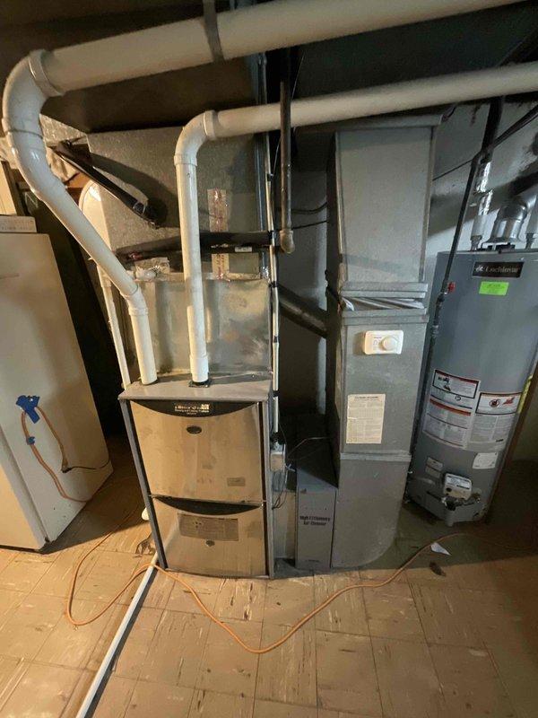 Completed HVAC system estimate for medium-sized residential heating system replacement in basement location. Evaluated existing natural gas furnace installation serving 1200-2000 square foot area, assessed current ductwork configuration, PVC venting infrastructure, and electrical connections. Provided comprehensive replacement quote for new gas-fired heating unit with proper sizing specifications based on existing mechanical room layout and utility connections.