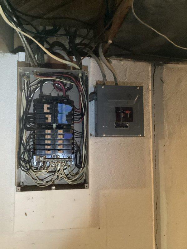 Conducted on-site assessment of existing 60-amp electrical service in 1960s single-family residence to provide estimate for panel upgrade to 150-amp service. Inspected current electrical panel installation located in basement area, documenting existing breaker configuration, wire sizing, panel condition, and service entrance equipment. Evaluated existing subpanel and disconnect box, noting current wiring methods and circuit distribution. Assessed structural considerations including available space for new panel installation, service entrance location, and necessary modifications to accommodate upgraded electrical service. Photographed existing electrical infrastructure to document current conditions for estimate preparation.