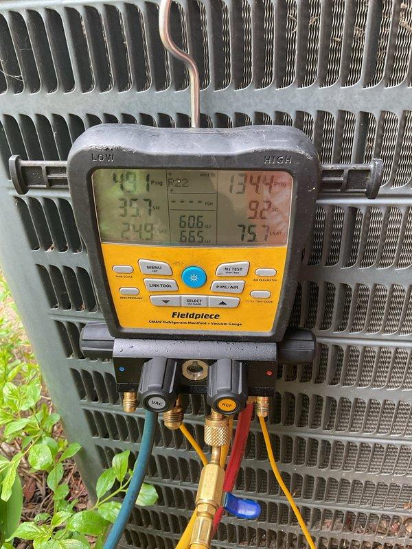 Performed annual cooling maintenance on residential air conditioning system. Used digital manifold gauges to measure system pressures and temperatures, recording suction side temperature of 35.7°F and discharge side temperature of 92°F, with superheat and subcool readings within normal operating parameters. Inspected condenser coil fins, which were found to be in good condition with proper spacing and no visible damage or blockage.