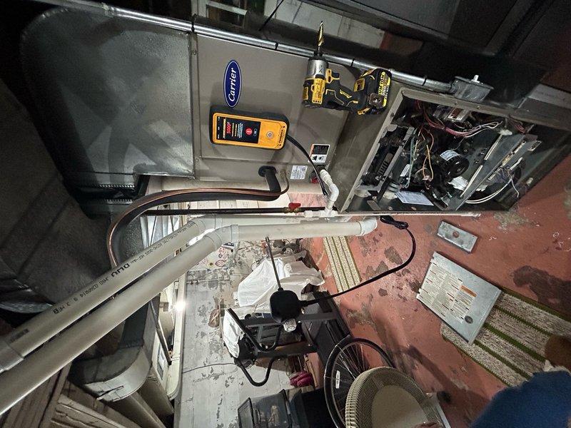 Responded to no heat call with thermostat not functioning and furnace inoperative, though blower motor was running. Upon arrival, performed diagnostic testing on Carrier furnace system using digital multimeter and amp clamp meters. Inspected furnace components, electrical connections, and control board operations. Verified proper venting through PVC intake and exhaust pipes on exterior. Identified loss of power to thermostat circuit as primary issue preventing system operation. Tested voltage at transformer, control board, and thermostat terminals to isolate failure point. Restored heating functionality by addressing electrical fault in low-voltage control circuit. Confirmed proper ignition sequence, burner operation, and heat exchanger temperature rise. Verified thermostat display illuminated and responding to commands. Cycled system multiple times to ensure reliable operation and proper safety control functions. Left system operational with heat delivering to living space.