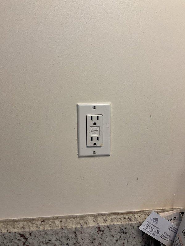 Responded to service call for non-functioning outlets in bedroom and bathroom on main floor of 30-year-old residence. Issue originated following blow dryer malfunction approximately 20 days prior. Upon arrival, confirmed outlets were without power despite homeowner's attempts to reset breakers and cycle all accessible GFCI receptacles.

Performed systematic circuit tracing to identify affected outlets on the circuit. Located faulty GFCI receptacle that had tripped and failed to reset properly. Tested GFCI functionality using electrical tester to confirm internal failure of protective mechanism. Replaced defective GFCI outlet with new unit meeting current code requirements. Verified proper wiring connections, confirmed correct line and load side terminations, and ensured adequate grounding. Tested new GFCI receptacle using test button and electrical testing device to verify proper trip and reset functionality. Restored power to all downstream outlets on circuit. Confirmed all affected b