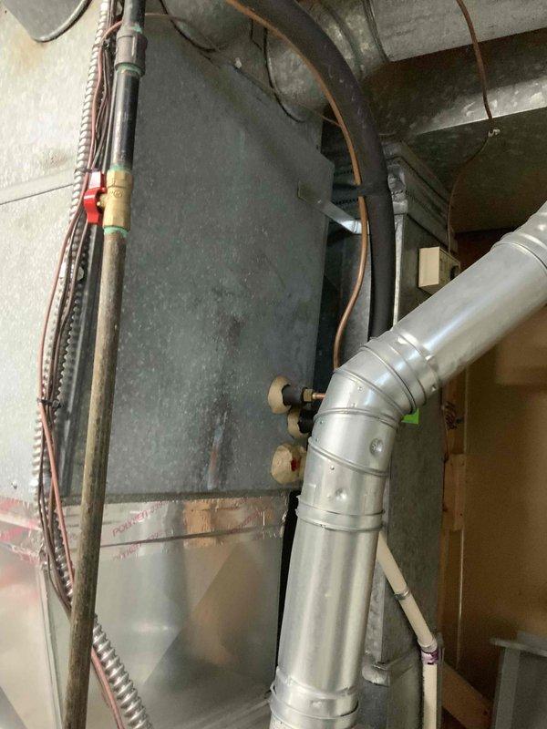 Conducted comprehensive assessment of 28-year-old air conditioning system and natural gas furnace located in basement for equipment replacement estimate. Evaluated existing HVAC infrastructure, ductwork configuration, and mechanical components to determine replacement specifications and system compatibility. Documented current equipment condition, measured existing plenum and supply duct connections, and photographed installation area to develop accurate replacement proposal for complete system upgrade.