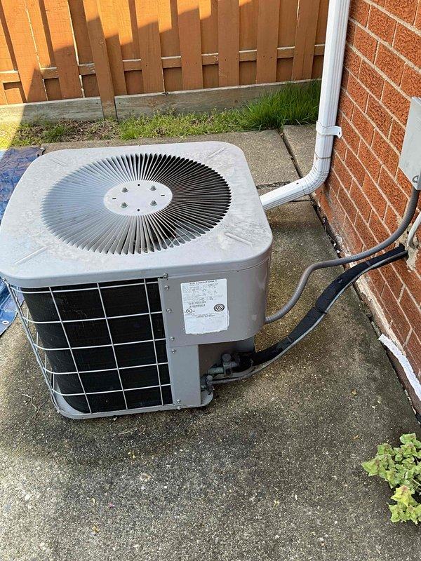 Conducted on-site evaluation of an 18-year-old residential air conditioning system experiencing refrigerant leaks and operational failure. Inspected outdoor condenser unit, indoor air handler, ductwork connections, and assessed overall system condition to provide replacement estimate. Documented existing equipment specifications and installation configuration with photographs for proposal development.