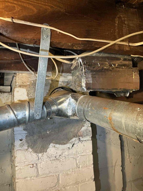 Conducted comprehensive full system HVAC assessment for replacement of existing 16-year-old furnace, addition of air conditioning system, and water heater replacement. Inspected basement installation area, evaluating existing ductwork infrastructure, electrical panel capacity, and structural support requirements. Documented current system configuration including aged metallic ductwork with visible oxidation, galvanized support strapping, and electrical service accessibility. Provided complete system replacement estimate covering furnace installation, new A/C unit addition, and water heater replacement to address immediate heating, cooling, and domestic hot water needs within requested timeline.