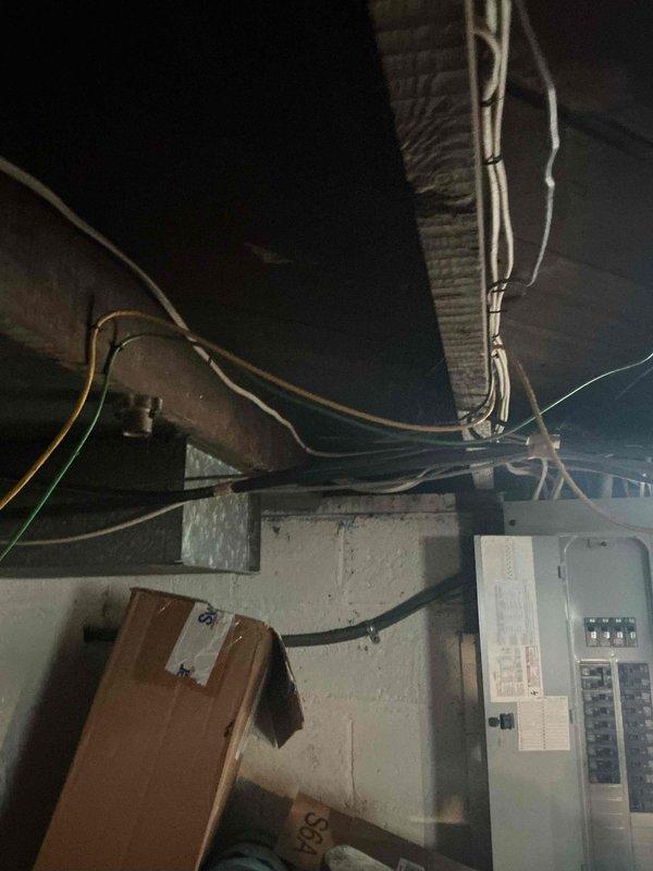 Conducted comprehensive full system HVAC assessment for replacement of existing 16-year-old furnace, addition of air conditioning system, and water heater replacement. Inspected basement installation area, evaluating existing ductwork infrastructure, electrical panel capacity, and structural support requirements. Documented current system configuration including aged metallic ductwork with visible oxidation, galvanized support strapping, and electrical service accessibility. Provided complete system replacement estimate covering furnace installation, new A/C unit addition, and water heater replacement to address immediate heating, cooling, and domestic hot water needs within requested timeline.
