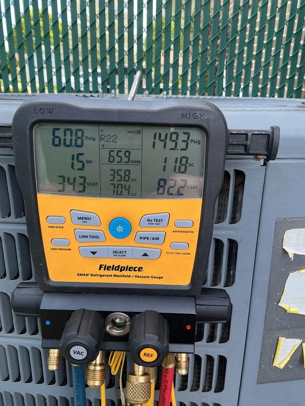Performed routine air conditioning maintenance on residential condenser unit. Conducted refrigerant pressure analysis using manifold gauges, recording low-side pressure at 60.8 PSIG with 15°F superheat and high-side pressure at 149.3 PSIG, confirming system operating within normal parameters. Inspected condenser unit exterior condition, verified proper airflow through louvered panels, and documented equipment status with unit positioned on concrete pad with adequate clearance.