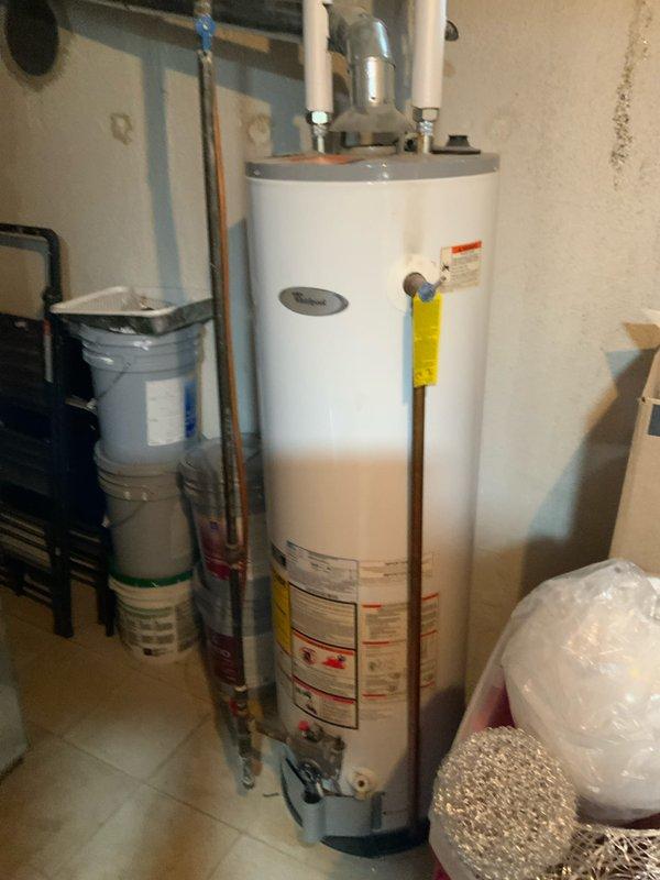 Conducted on-site assessment for standard water heater replacement in residential utility room. Evaluated existing functional water heater installation, including connected copper supply lines, PVC drain piping, pressure relief valve configuration, and proximity to water softener system. Documented current equipment specifications, plumbing connections, and surrounding utility infrastructure to prepare accurate replacement estimate for standard tank-type water heater unit.
