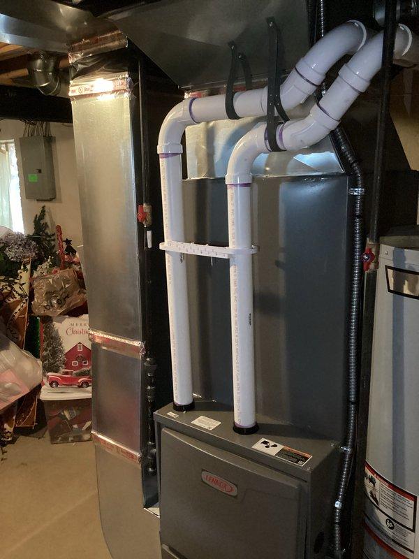 Completed full HVAC system installation including a 90,000 BTU gas furnace and 3-ton air conditioning unit with rear discharge configuration. Installed new PVC venting system properly secured to ceiling joists with appropriate hangers and clamps, routed electrical connections using flexible conduit, and reconnected all utilities. All mechanical and electrical permits obtained, equipment properly positioned in basement utility area, and system tested for proper operation upon completion.