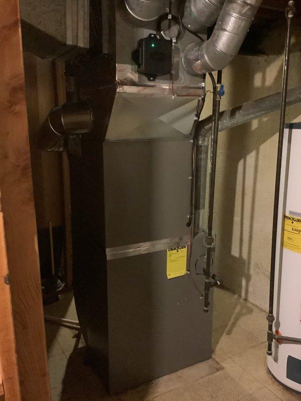 Completed installation of 2.5-ton air conditioning system with matching evaporator coil in residential basement location. Installation included mechanical and electrical connections, rear-positioned outdoor unit hookup, and reconnection of existing humidifier to the system. All ductwork properly sealed and connected, refrigerant lines installed and charged to manufacturer specifications, condensate drain line established, and system tested for proper operation and airflow.