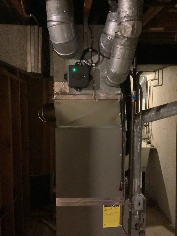 Completed installation of 2.5-ton air conditioning system with matching evaporator coil in residential basement location. Installation included mechanical and electrical connections, rear-positioned outdoor unit hookup, and reconnection of existing humidifier to the system. All ductwork properly sealed and connected, refrigerant lines installed and charged to manufacturer specifications, condensate drain line established, and system tested for proper operation and airflow.