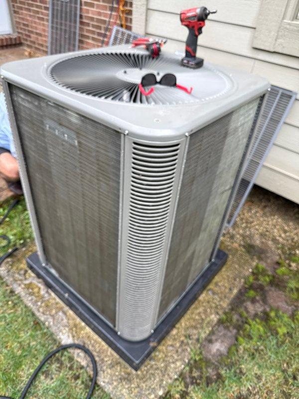 Performed annual preventive maintenance on residential split system air conditioning unit. Inspected condenser unit exterior panels, verified proper airflow through louvered sides, and checked fan grille assembly for secure mounting and operational integrity. Unit found in good working condition with all components functioning as designed.
