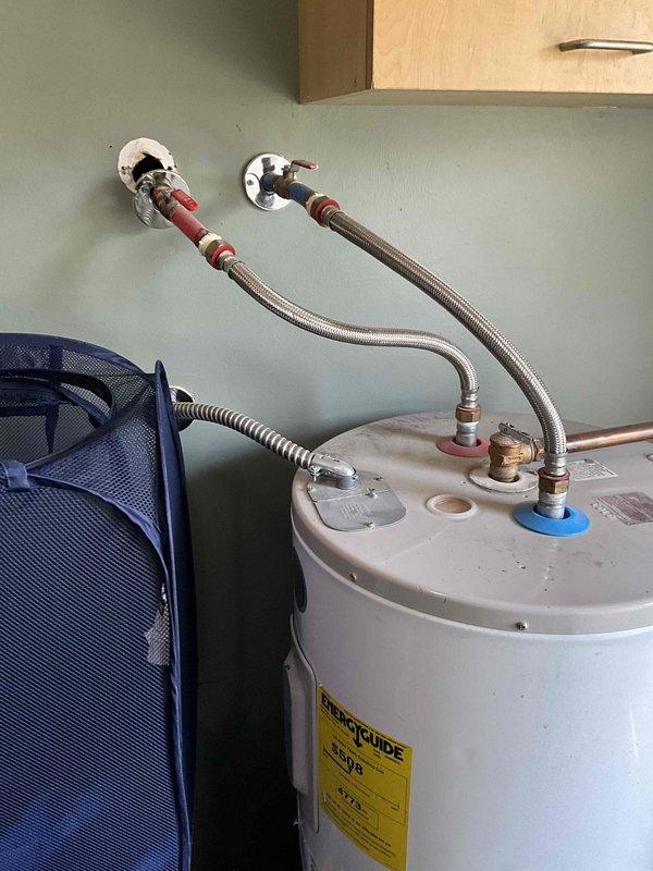 Conducted on-site evaluation of existing conventional tank-style water heater to provide replacement estimate. Assessed current unit's condition, plumbing connections including flexible braided supply lines with wall-mounted isolation valves, copper piping configuration, and pressure relief valve assembly. Documented installation specifications and utility space dimensions to develop comprehensive proposal comparing conventional tank replacement versus tankless water heater conversion options for customer consideration.