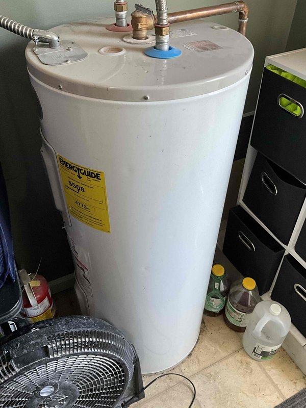 Conducted on-site evaluation of existing conventional tank-style water heater to provide replacement estimate. Assessed current unit's condition, plumbing connections including flexible braided supply lines with wall-mounted isolation valves, copper piping configuration, and pressure relief valve assembly. Documented installation specifications and utility space dimensions to develop comprehensive proposal comparing conventional tank replacement versus tankless water heater conversion options for customer consideration.