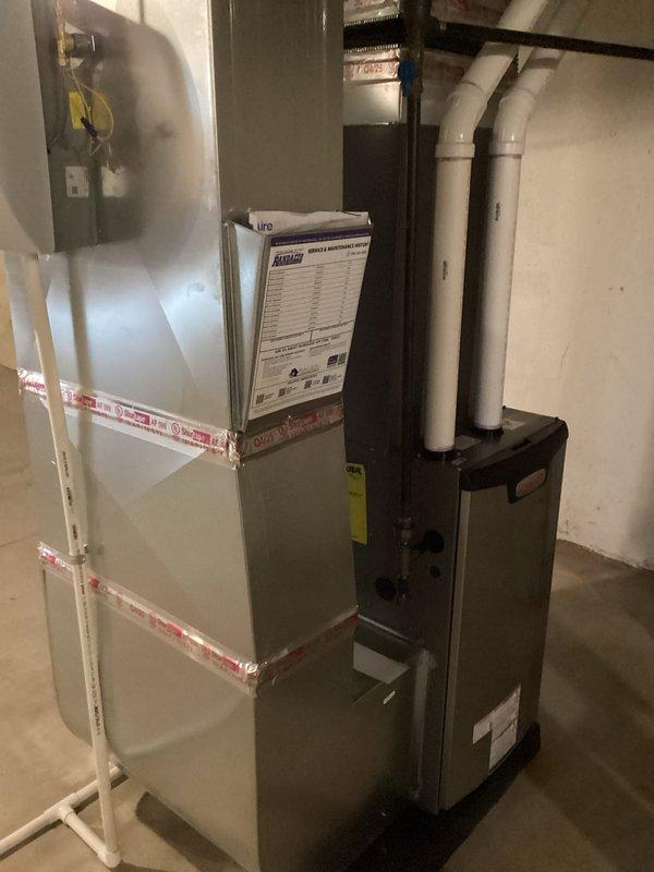 Completed full HVAC system installation including 70,000 BTU gas furnace with humidifier and 2.5-ton air conditioning unit with rear discharge configuration. Installed new air handler on elevated platform in basement utility area, ran PVC condensate drain lines, and connected refrigerant line set with proper insulation. Mounted electrical disconnect, completed all ductwork connections, and reconnected existing components to new equipment. Obtained mechanical and electrical permits prior to installation. All equipment installed per manufacturer specifications, system tested and operational, with utility rebate applications processed for DTE and SEMCO programs.