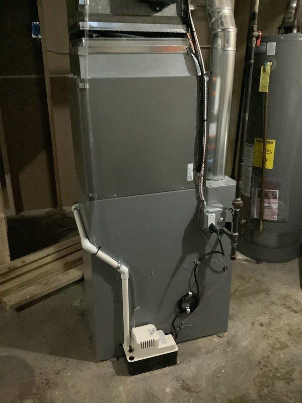 Completed installation of 2-ton evaporator coil and air handler unit in basement utility area, with all ductwork connections properly secured and routed. Reconnected existing condenser unit per customer request, verified refrigerant lines, electrical connections, and condensate drainage system functioning properly. System tested and operational with all mechanical and electrical permits obtained.