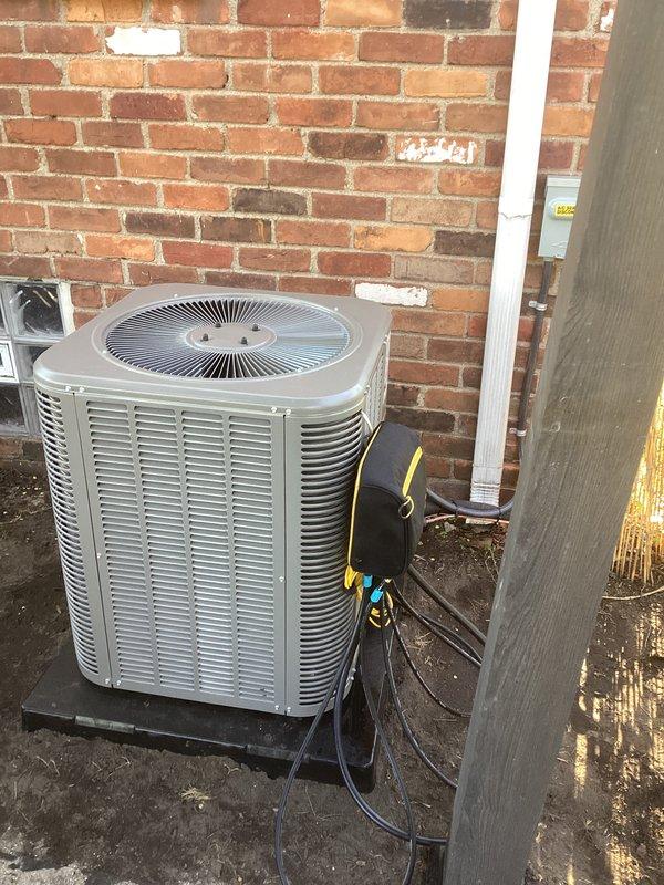 Completed full HVAC system installation including a 70,000 BTU furnace and 2-ton air conditioning unit in basement mechanical room. Installed new electrical circuit to support equipment, ran condensate drain lines via white PVC piping, and connected metallic ductwork to existing distribution system. Positioned outdoor condenser unit on platform against exterior brick wall with proper electrical disconnect and refrigerant line connections. Obtained mechanical and electrical permits prior to installation. System tested and operational upon completion.