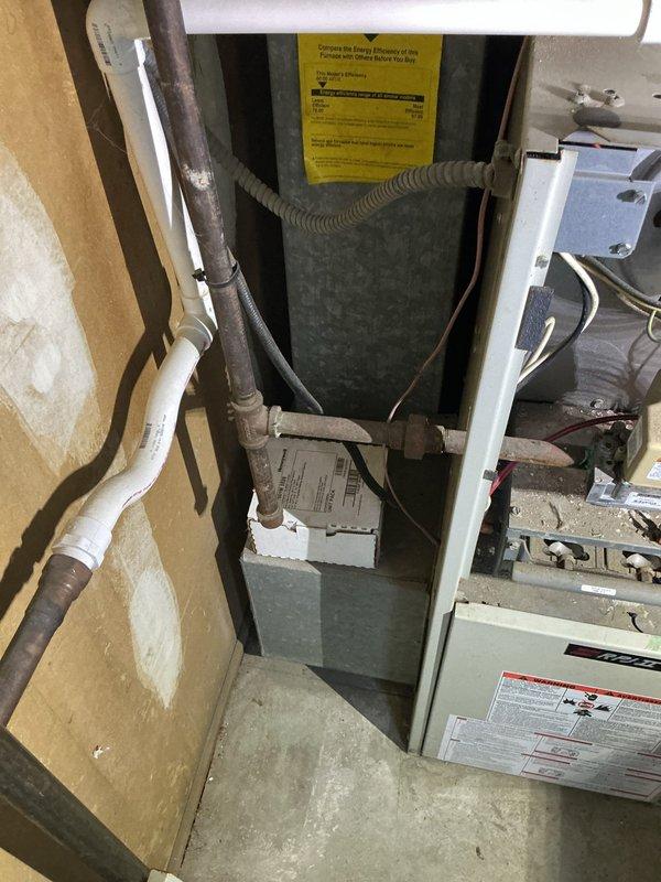 Responded to gas leak emergency at furnace unit where utility company had shut off gas supply for safety. Performed visual inspection of furnace cabinet and internal components including blower assembly, motor housing, and gas connections. Documented current system condition with photographs showing interior cabinet layout, PVC venting, and blower motor assembly with electrical connections. Unit remains offline pending further diagnostics and repair of gas leak source.