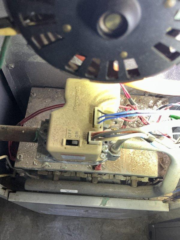 Responded to gas leak emergency at furnace unit where utility company had shut off gas supply for safety. Performed visual inspection of furnace cabinet and internal components including blower assembly, motor housing, and gas connections. Documented current system condition with photographs showing interior cabinet layout, PVC venting, and blower motor assembly with electrical connections. Unit remains offline pending further diagnostics and repair of gas leak source.