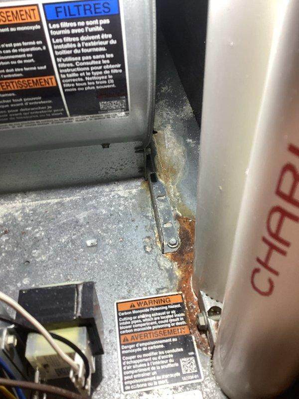 Completed annual cooling maintenance on HVAC system. Inspected thermostat operation and confirmed proper temperature readings and WiFi connectivity. Noted significant rust and corrosion on interior metal components and mounting brackets, along with dust accumulation throughout the unit. Filter replacement required and recommended due to visible debris and system conditions.