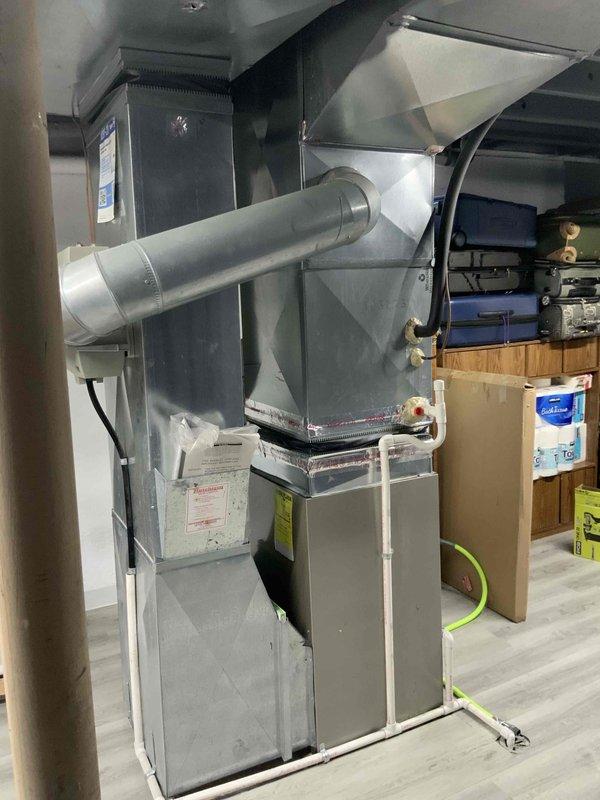 Conducted on-site evaluation of 26-year-old air conditioning system for replacement estimate. Assessed existing HVAC equipment including furnace, ductwork, and condensing unit configuration in residential basement installation. Provided customer with replacement options and information regarding current promotional offers available for new system installation.