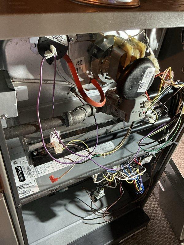 Completed annual heating and cooling maintenance inspection on residential HVAC system. Performed comprehensive inspection of furnace internal components including blower motor, gas valve assembly, heat exchanger, ignition system, and all electrical connections. Verified proper operation of all safety controls and checked refrigerant lines for secure connections. Inspected outdoor condensing unit, noting filter accumulation on top grille requiring attention. All mechanical and electrical components functioning within normal operating parameters at time of inspection.