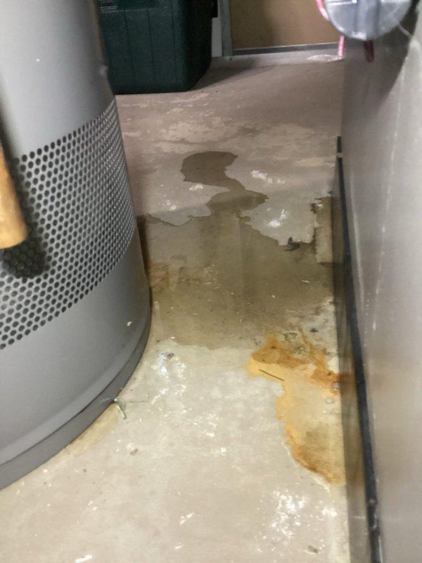 Responded to water heater emergency in basement utility room where tanked water heater exhibited active leaking from bottom of tank and loud banging noises during operation. Upon arrival, found significant water accumulation across utility room floor with visible pooling and evidence of rust-contaminated water discharge. Performed diagnostic inspection of water heater tank and identified bottom tank failure with internal corrosion causing water leakage directly from tank body. Loud banging noise confirmed as sediment buildup creating steam pockets during heating cycle, indicating advanced deterioration. Documented extensive floor water damage and compromised tank integrity through photographic evidence. Advised that bottom tank leaks are non-repairable due to structural failure of tank vessel and recommended complete water heater replacement as only viable solution. Unit determined to be beyond serviceable condition due to tank rupture and sediment accumulation.