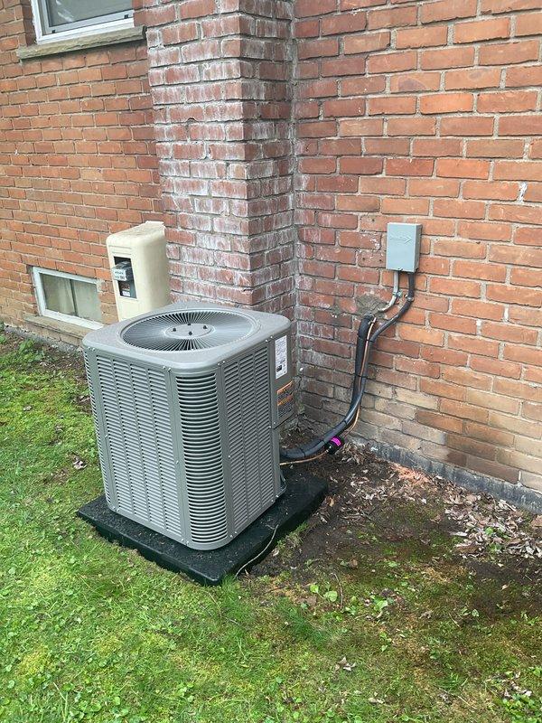 Completed full HVAC system installation including a 70,000 BTU furnace with liner and 2-ton air conditioning unit configured for left-side placement. Installed outdoor condenser unit on rubber pad with proper refrigerant line routing, electrical conduit, and disconnect box mounted to exterior brick wall. Ran metallic flexible ductwork through interior basement space and reconnected all necessary electrical and mechanical connections per mechanical and electrical permits.