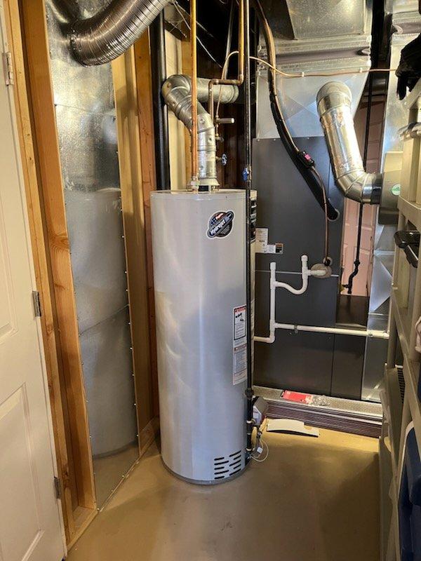 Responded to service call for 15-year-old tanked water heater experiencing operational failure with 5-flash error code and shutting down after approximately 10 minutes of runtime. Upon arrival, performed diagnostic inspection of the unit and associated venting system. Evaluated gas supply, burner assembly, thermocouple, and control board functionality. Inspected flue venting configuration and clearances. Assessed electrical connections and grounding. Based on age of equipment and diagnostic findings, provided customer with repair versus replacement options and recommendations. No parts were installed and no repairs were performed at this time. Documented existing installation with photos showing water heater, venting system, and surrounding mechanical equipment for reference.