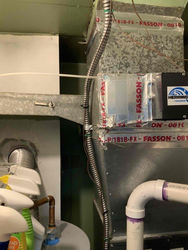 Provided replacement estimate for non-operational air conditioning system over 30 years old located in utility closet alongside existing Goodman furnace and water heater. Assessed current equipment configuration including ductwork system with metal supply plenum and flexible ducting routed through confined space, evaluated existing PVC condensate drain lines and gas connections for compatibility with replacement unit specifications.