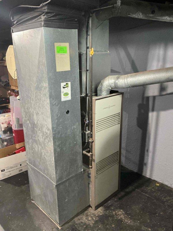 Completed full system estimate for replacement of 15-year-old furnace and air conditioning system in residential basement mechanical room. Assessed existing equipment condition, including furnace with mounted humidifier component and air handler unit with associated ductwork. Customer requested immediate replacement quote for outdated HVAC system. Documented current equipment configuration and specifications through photographic documentation of furnace, air handler, ductwork, and electrical connections to provide accurate replacement system recommendations.
