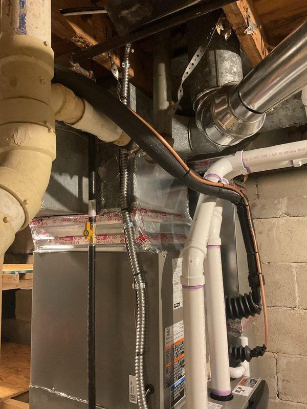 Completed full HVAC system installation including a 70,000 BTU furnace and 2-ton air conditioning unit with right-side placement. Installed new air handler in basement utility space with associated PVC condensate drainage system, insulated refrigerant lines, and electrical conduit connections. Positioned outdoor condensing unit on pad adjacent to building exterior with proper service clearances and reconnected all refrigerant lines and electrical service. Obtained mechanical and electrical permits prior to installation. Configured complete ductwork integration including plenum transitions and verified all system connections. Submitted completion certificate documentation and finalized all required paperwork for energy efficiency program compliance.