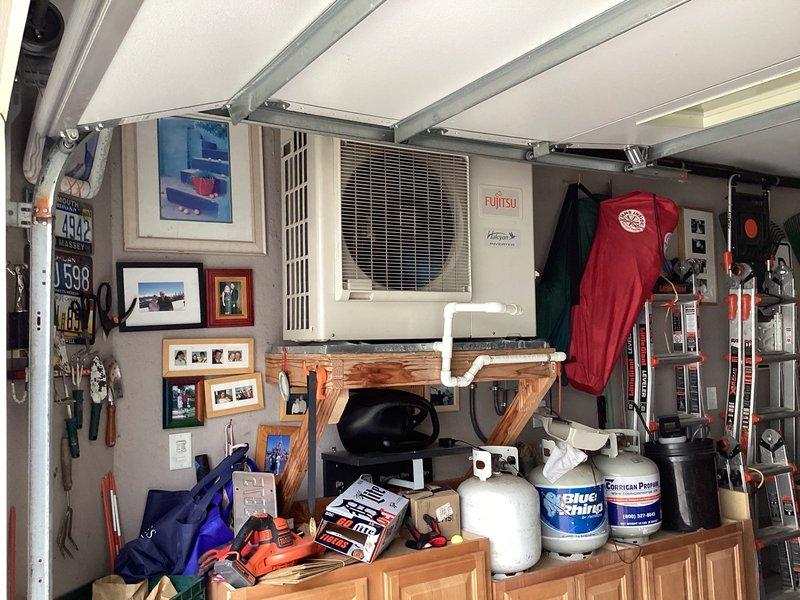 Responded to service call for 10-year-old Fujitsu mini split system (Model AOU30RLX, Serial JPN004209) located in garage with no activity and fan cycling on for one minute before shutting off. Performed diagnostic evaluation of indoor wall-mounted unit and outdoor condensing unit to identify cause of intermittent operation and system failure. Documented equipment condition and communicated findings regarding the non-operational mini split system.