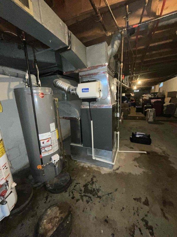 Provided estimate for new air conditioning system installation in basement location where no existing A/C unit is currently present. Assessed basement utility area with existing air handler and mechanical equipment to determine optimal placement and integration requirements for new cooling system, including evaluation of available electrical service, gas meter accessibility, and ductwork connections to support complete A/C installation.