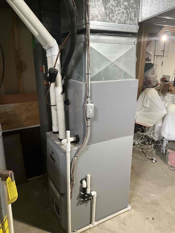 Provided full system replacement estimate for aging HVAC system with critically low refrigerant in outdoor condensing unit. Assessed 6-year-old Goodman 3-ton AC unit (Model 4AC13L36P-10A) showing significant refrigerant loss, 10+ year-old evaporator coil, and approximately 10-year-old forced-air furnace with existing ductwork in basement installation. Recommended complete system replacement rather than repair due to age of components and cost-effectiveness of new equipment installation.