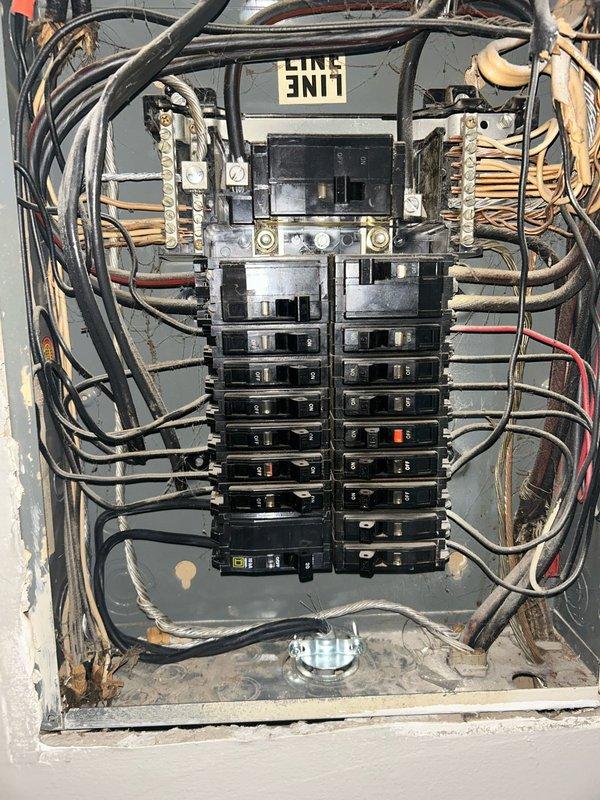 Responded to callback for HVAC installation. Performed electrical inspection of main service panel and exterior disconnect box. Documented existing electrical infrastructure including circuit breaker configuration, conductor routing, bus bar connections, and grounding system. Verified electrical service entrance components and weatherhead connections. Inspected outdoor electrical enclosure showing age-related weathering and corrosion on terminals and hardware. Captured photographic documentation of both interior panel wiring arrangement and exterior service entrance for installation records and future reference.