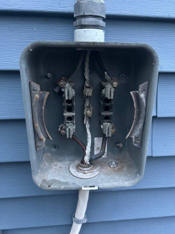 Responded to callback for HVAC installation. Performed electrical inspection of main service panel and exterior disconnect box. Documented existing electrical infrastructure including circuit breaker configuration, conductor routing, bus bar connections, and grounding system. Verified electrical service entrance components and weatherhead connections. Inspected outdoor electrical enclosure showing age-related weathering and corrosion on terminals and hardware. Captured photographic documentation of both interior panel wiring arrangement and exterior service entrance for installation records and future reference.