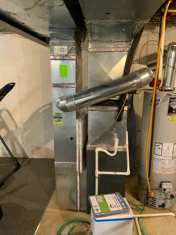 Conducted home show appointment to assess residential HVAC system and indoor air quality requirements for potential zoning installation. Inspected basement mechanical room containing existing furnace with horizontal stainless steel venting, water heater, and ductwork configuration. Documented equipment layout and structural conditions to determine feasibility of humidifier and zoning system installation based on home type and square footage.