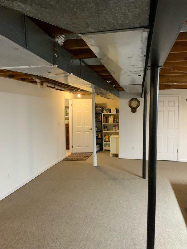 Conducted home show appointment to assess residential HVAC system and indoor air quality requirements for potential zoning installation. Inspected basement mechanical room containing existing furnace with horizontal stainless steel venting, water heater, and ductwork configuration. Documented equipment layout and structural conditions to determine feasibility of humidifier and zoning system installation based on home type and square footage.