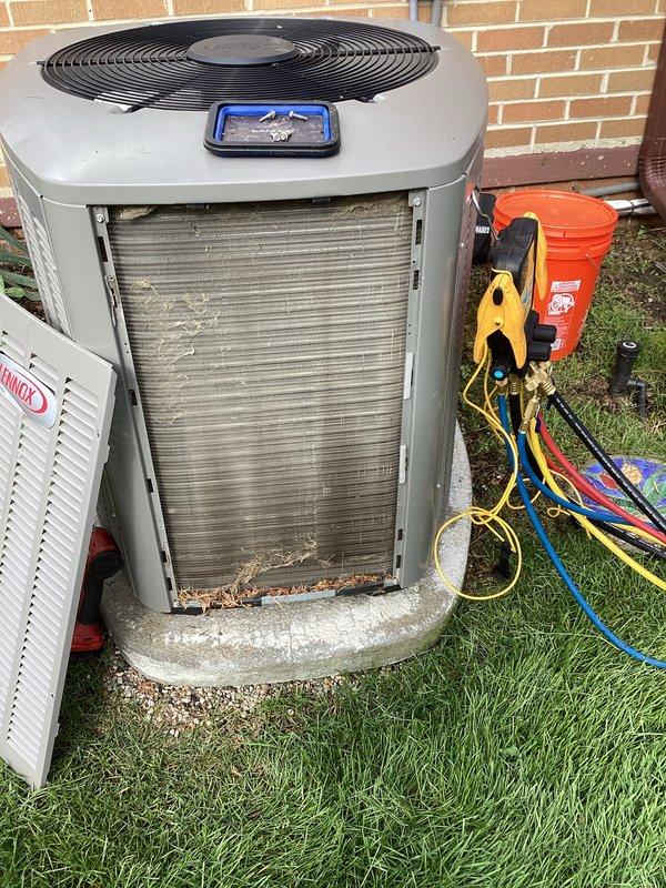 Completed annual cooling maintenance on outdoor condensing unit. Performed comprehensive system inspection, checked refrigerant pressures and temperatures using manifold gauges, cleaned condenser coils which showed moderate debris accumulation and discoloration, and verified proper fan operation. Noted minor surface rust at unit base but unit operating within normal parameters.