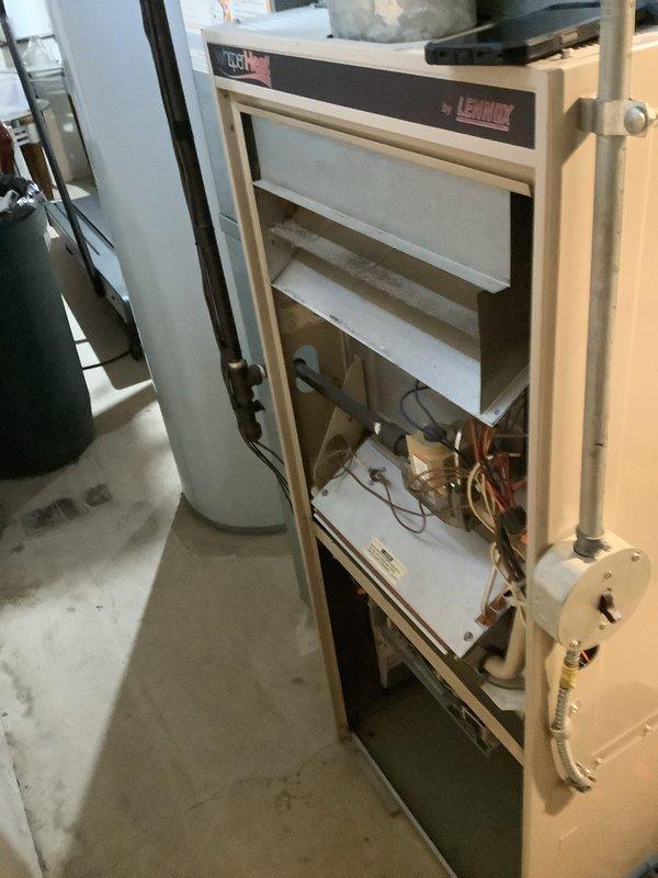 Performed city rental certification inspection on residential Lennox gas furnace located in basement. Completed comprehensive system evaluation including visual inspection of heat exchanger, burner assembly, gas valve, and all safety controls. Verified proper operation of blower motor, checked electrical connections, and inspected venting system including PVC condensate drain lines. Removed front access panel to examine internal components, confirming heat exchanger integrity and absence of cracks or corrosion. Tested furnace ignition sequence, flame sensor operation, and limit switch functionality. Documented system condition with photographs showing cabinet interior, heat exchanger baffles, copper refrigerant lines, and control modules. Unit found to be operating within manufacturer specifications and meeting city certification requirements for rental property compliance.