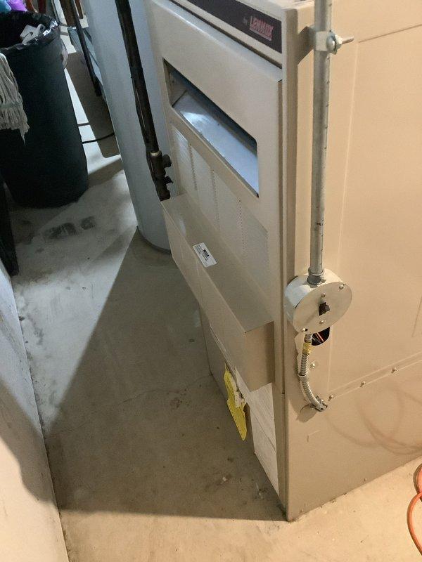 Performed city rental certification inspection on residential Lennox gas furnace located in basement. Completed comprehensive system evaluation including visual inspection of heat exchanger, burner assembly, gas valve, and all safety controls. Verified proper operation of blower motor, checked electrical connections, and inspected venting system including PVC condensate drain lines. Removed front access panel to examine internal components, confirming heat exchanger integrity and absence of cracks or corrosion. Tested furnace ignition sequence, flame sensor operation, and limit switch functionality. Documented system condition with photographs showing cabinet interior, heat exchanger baffles, copper refrigerant lines, and control modules. Unit found to be operating within manufacturer specifications and meeting city certification requirements for rental property compliance.