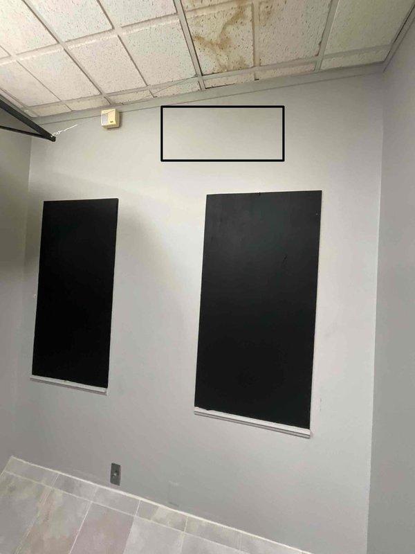 Conducted site assessment for installation of second mini-split system in server room of commercial facility. Evaluated electrical panel capacity and confirmed adequate breaker space available for additional unit. Documented existing conditions including ceiling infrastructure with drop tile system and wall-mounted equipment, noting moisture damage present on ceiling tiles that may require attention during installation to ensure proper drainage routing for new condensate lines.