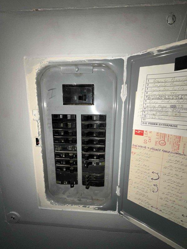 Conducted site assessment for installation of second mini-split system in server room of commercial facility. Evaluated electrical panel capacity and confirmed adequate breaker space available for additional unit. Documented existing conditions including ceiling infrastructure with drop tile system and wall-mounted equipment, noting moisture damage present on ceiling tiles that may require attention during installation to ensure proper drainage routing for new condensate lines.