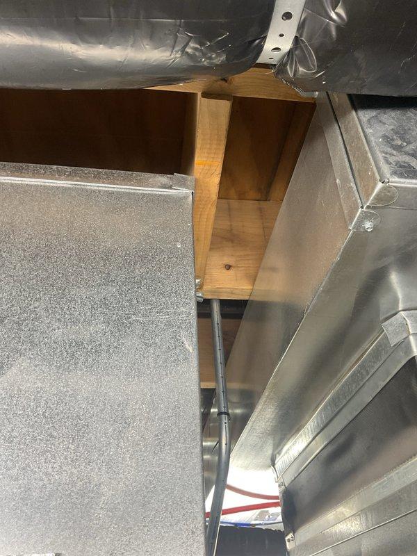 Responded to installation callback to address clearance concern at plenum control box. Inspected gas shut-off valve positioning relative to overhead ductwork and confirmed adequate one-inch clearance requirement at top of plenum. Documented existing installation configuration with photographs showing gas flex line routing, ductwork placement, and control box accessibility for compliance verification.