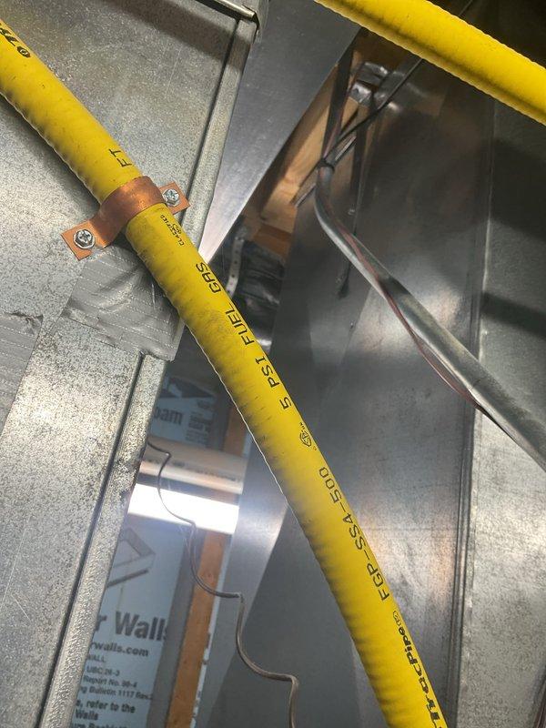 Responded to installation callback to address clearance concern at plenum control box. Inspected gas shut-off valve positioning relative to overhead ductwork and confirmed adequate one-inch clearance requirement at top of plenum. Documented existing installation configuration with photographs showing gas flex line routing, ductwork placement, and control box accessibility for compliance verification.