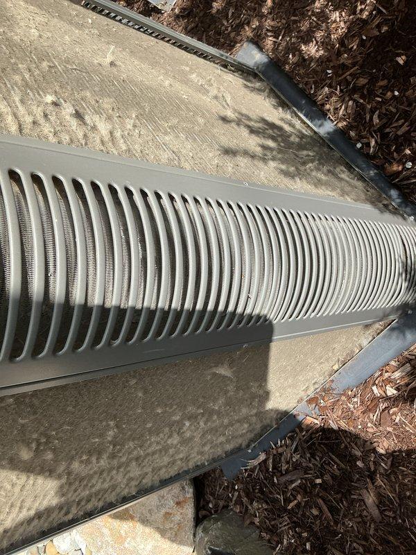 Completed annual preventive maintenance on residential RZ cooling system. Inspected outdoor condensing unit, verified proper airflow through coil fins and intake louvers, confirmed unit operational status, and documented equipment condition with photos. No filter replacement required during this service visit.