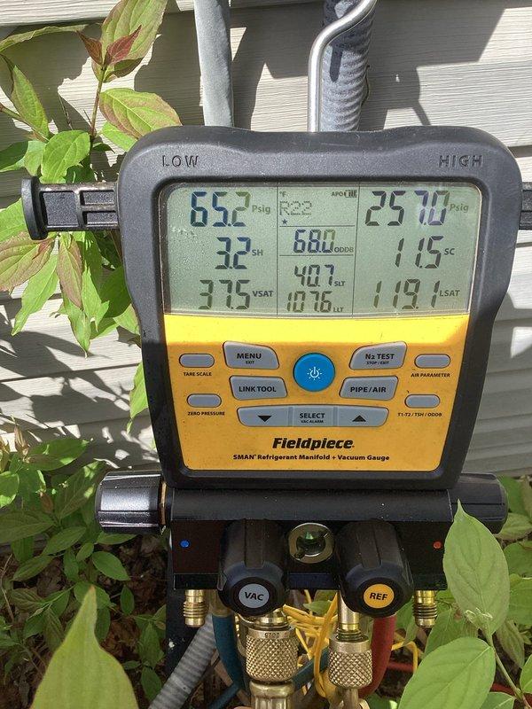 Completed annual cooling maintenance on air conditioning system. Performed system diagnostics with refrigerant manifold gauge set, recording operating pressures of 65.2 PSIG on low side and 257.2 PSIG on high side with superheat and subcooling measurements within acceptable parameters. Inspected air return grille and ventilation components for proper airflow and structural integrity.