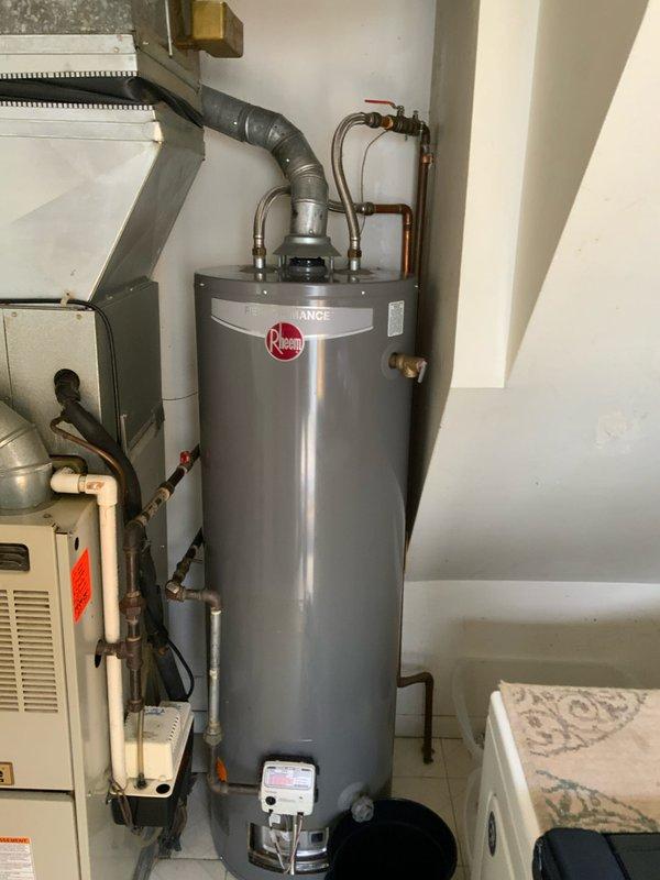 Provided comprehensive estimate for complete HVAC system replacement in utility room, including 30-35 year old furnace, air conditioning unit, and non-functional Rheem water heater. Assessment revealed aging equipment with visible water damage to ceiling panel indicating potential leak history from existing water heater connections. Recommended full system upgrade to modern, energy-efficient equipment to address failed water heater and prevent future reliability issues with deteriorating HVAC components.